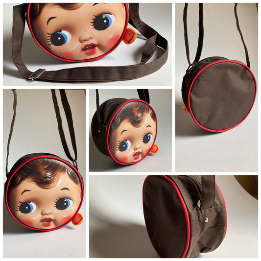 Schultertasche Puppengesicht